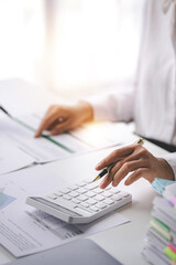 Portrait of a woman working on a tablet computer in a modern office. Make an account analysis report. real estate investment information financial and tax system concepts