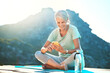 © Haas/peopleimages.com - Yoga, music and phone with old woman in nature for social media, streaming and podcast. Meditation, radio and internet with senior yogi browsing online in outdoors for peace, fitness app and audio