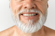© master1305 - Cropped close-up image of grey-haired man's beard. Mature male model smiling against grey background. Dental teeth care. Concept of male beauty, face and skin care, daily procedures, age