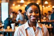 © Pictures Paradise - Portrait of smiling african american waitress in elegant restaurant looking at camera with bokeh background.