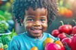 © Pictures Paradise - Happy African American black little boy with fruits.Portrait of a happy greengrocer standing in front of the vegetables.Grocery. Copy space text.