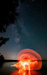 Wall Mural - Beautiful light painting against the background of the starry sky.