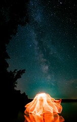 Wall Mural - Beautiful light painting against the background of the starry sky.