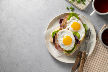 Breakfast food, fried eggs with bacon on toast. Top view, copy space