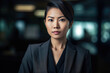 © Ladanifer - Portrait of asian businesswoman in dark office. Generative AI.