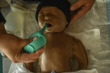 Closeup Of A Plastic Resuscitation Baby With Some Tools