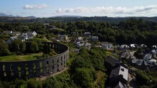 Drone Moving Above The Battery Hill's Houses And Trees, Showing The McCaig's Tower On The Left