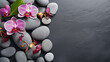 top view on a selection of smooth stones and orchids building a wellness background