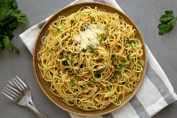 Wall Mural - Homemade Italian Spaghetti Aglio e Olio on a Plate, top view. Flat lay, overhead, from above.