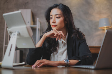 Attractive Businesswoman, manager or employee is having an idea for business project or planning, Thinking of information for job. Concept of focusing or having a motivation at workplace.