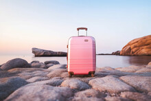 A Pink Suitcase By The Sea At Sunset. Generative AI