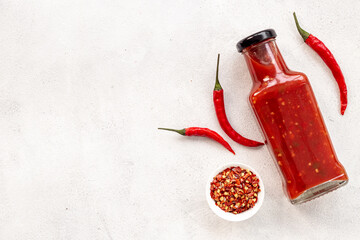 Wall Mural - Red chili pepper sauce in bottle with ripe hot pepper