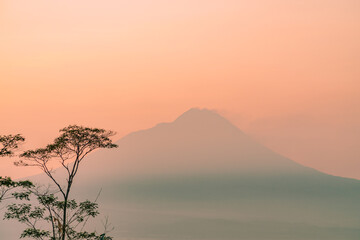 Wall Mural - Mount Merapi close up view of the sunrise. Mount Merapi is a mountain located in Indonesia. The most active volcano in Indonesia