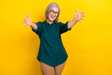 Poster - Photo of positive candid aged lady raise opened arm invite welcome you isolated on yellow color background