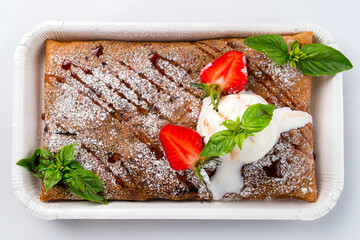 Wall Mural - Fried sweet thin pancakes with cottage cheese, ice cream, fresh strawberry and basil on white background.