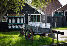 A Cart With Milk Cans On The Back Of The Cheese Dairy