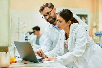 Wall Mural - two scientists working on computer in laboratory.