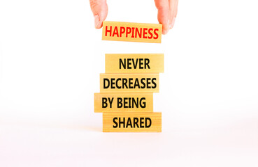 Wall Mural - Happiness symbol. Concept words Happiness never decreases by being shared on wooden block. Businessman hand. Beautiful white table white background. Motivational Happiness concept. Copy space.