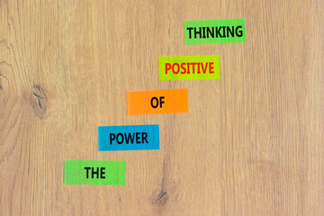 Wall Mural - Positive thinking symbol. Concept words The power of positive thinking on colored paper. Beautiful wooden table wooden background. Business, motivational positive thinking concept. Copy space.