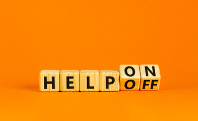Wall Mural - Help on or off symbol. Businessman turns wooden cubes and changes word Help off to Help on. Beautiful orange table orange background. Business and help on or off concept. Copy space.