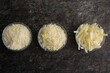 Freshly Grated and Shredded Parmesan Cheese in Glass Prep Bowls: Three different textures of grated and shredded parmesan cheese viewed from above