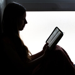 Canvas Print - silhouette of a girl with a book