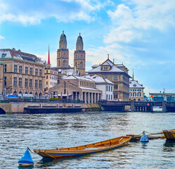 Poster - Grossmunster's towers and Limmat River with old wooden boats, moored at the Schipfe embankment, Zurich, Switzerland