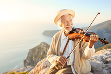 An Old Man Plays The Violin Against The Backdrop Of Sunset. Neural Network AI Generated