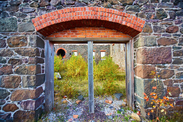 Wall Mural - Abandoned building no doors that open to courtyard of green plants stone archway no roof stone walls