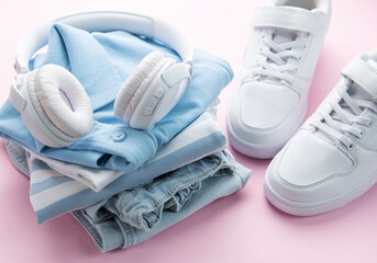 Wall Mural - Child's t-shirt, shoes and headphones on pink backgrund