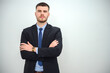 © เลิศลักษณ์ ทิพชัย - young businessman success Standing with arms crossed looking confident and smiling camera isolated over white wall background.