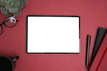 Wall Mural - Modern creative workspace top view with digital tablet mockup on red background.