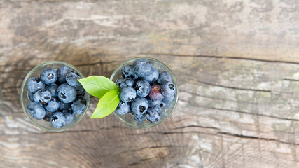 Canvas Print - Ripe blueberries on a wooden background. Fruit appetizing background.