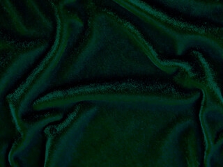 Green velvet fabric texture used as background. Empty green fabric background of soft and smooth textile material. There is space for text..