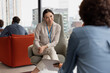 © ReeldealHD images - Female business executive listening in an informal meeting in office atrium reception