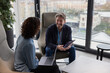 © ReeldealHD images - Two senior business executives in a meeting looking with a laptop and a digital tablet