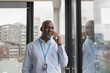 © ReeldealHD images - Senior black businessman in corporate office talking on smartphone