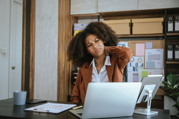 Wall Mural - Tired african american business woman working with audit, balance sheet, investing activities, safety stock, net loss, business risks, accumulated depreciation, factory overhead, accrued expense