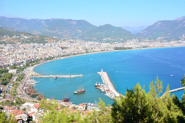 Wall Mural - A view of the sea and the city with the mountains on background