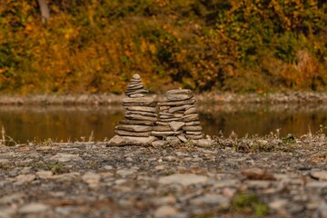 Sticker - Stone stacks on a lake shore in autumn