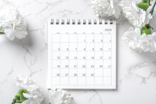 Calendar 2023 With White Carnation Flowers On Marble Background