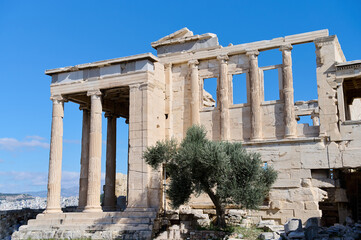 The ancient Parthenon temple in the Acropolis of Athens, Greece on a bright blue background. Remains of the building. Archaeological monument. Horizontal photo