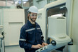 © visoot - Engineer operating cnc machine in control panel at factory,Industry 4.0 concept.