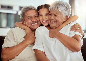 Home, grandparents hug portrait and family with child and happiness on a living room couch. Fun, smile and happy bonding with childcare, love and kid together with a young girl on a house sofa