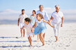© Alexis Scholtz/peopleimages.com - Holiday, happy and big family running on the beach for playing and bonding on a weekend trip. Travel, excited and children having fun with their grandparents and parents by the ocean on a vacation.