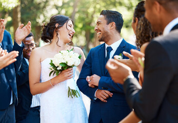 Wedding ceremony, couple and people clapping hands in celebration of love, romance and union. Happy, smile and bride with bouquet and groom walking by guests cheering for marriage at an outdoor event