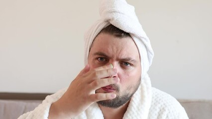 Wall Mural - funny bearded man applying green mask for skin care