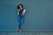 © Camerene Pendl/peopleimages.com - Thinking, planning and woman on a blue wall for business, career ideas or plan in an office. Smile, corporate and a young female employee with a notebook and idea or professional strategy with mockup