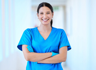 Woman, nurse and portrait with arms crossed and smile in a hospital and clinic. Employee, healthcare and wellness professional with happiness and confidence from doctor and medical work and care
