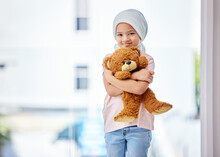 Healthcare, Child And Portrait Of A Cancer Patient Holding A Teddy Bear For Support Or Comfort. Medical, Smile And Girl Kid With Leukemia Standing With A Toy After Treatment In A Medicare Hospital.
